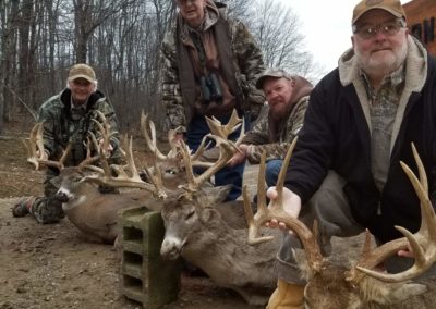 4 hunters with large bucks