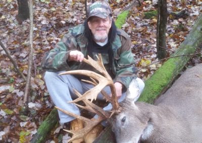 Old man on ground with large buck