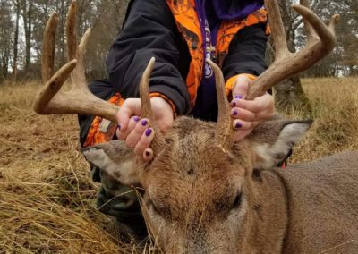 Young girl with purle hoodie with large buck