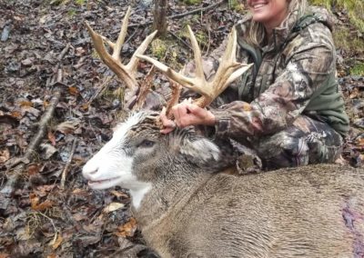Large buck and female hunter side view
