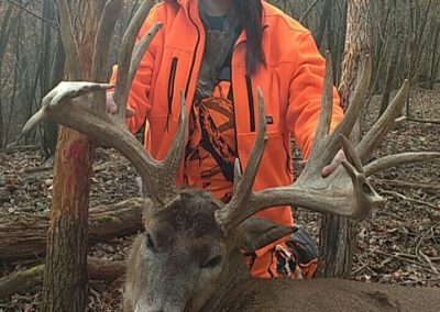 Young hunter girl with large buck
